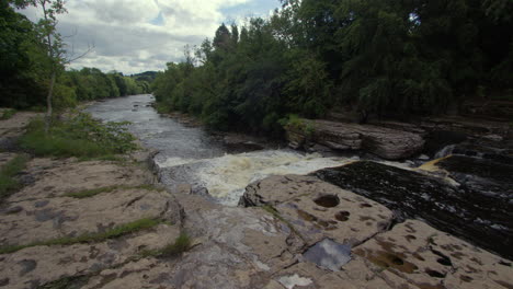 wide shot looking down the lower falls at aysgarth falls on the river ure, yorkshire dales