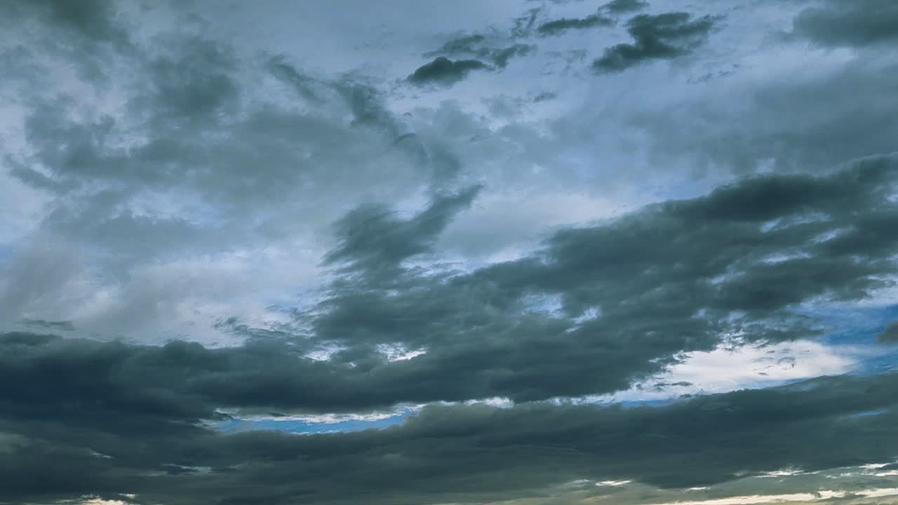 Timelapse of monsoon clouds moving across sky with dark, moody layers. Perfect for cinematic backgrounds, weather themes or nature transitions.