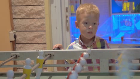 boy learning to play foosball