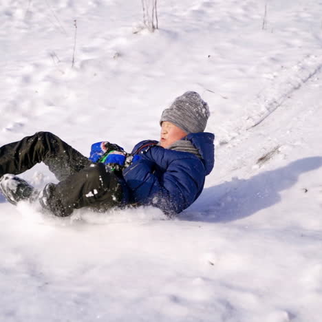 frost winter season. two children ride down a hill, winter games and fun. kids laughing, sledging down a hill. children ride down a hill, winter games and fun. slow motion.