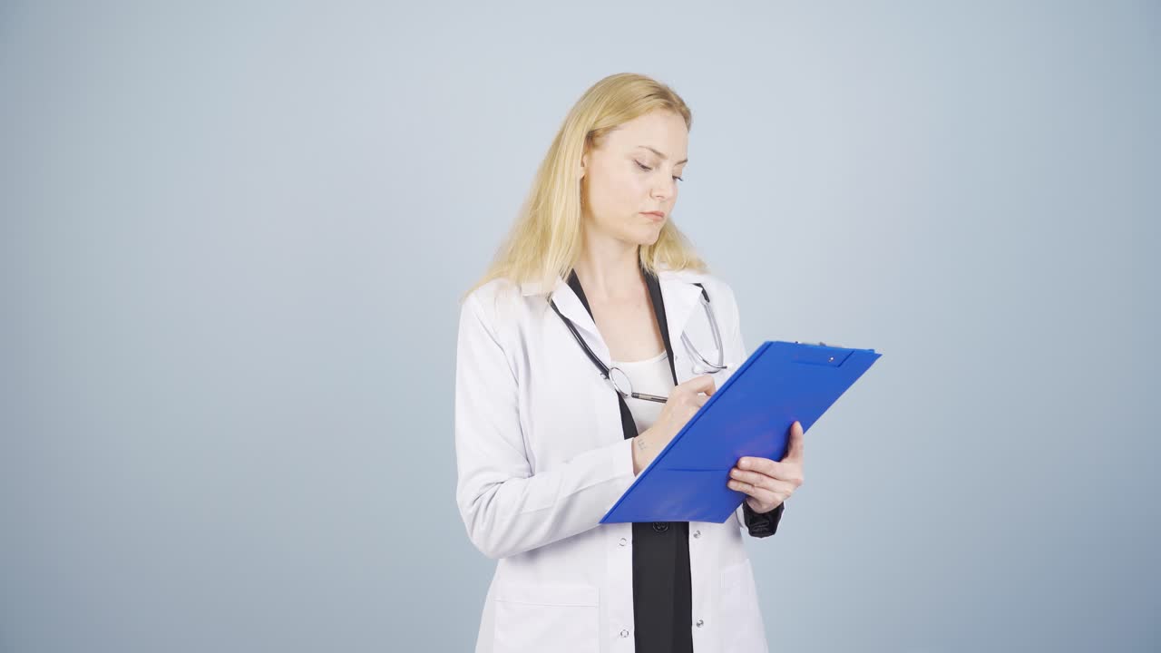 The doctor examining the paperwork is thoughtful.