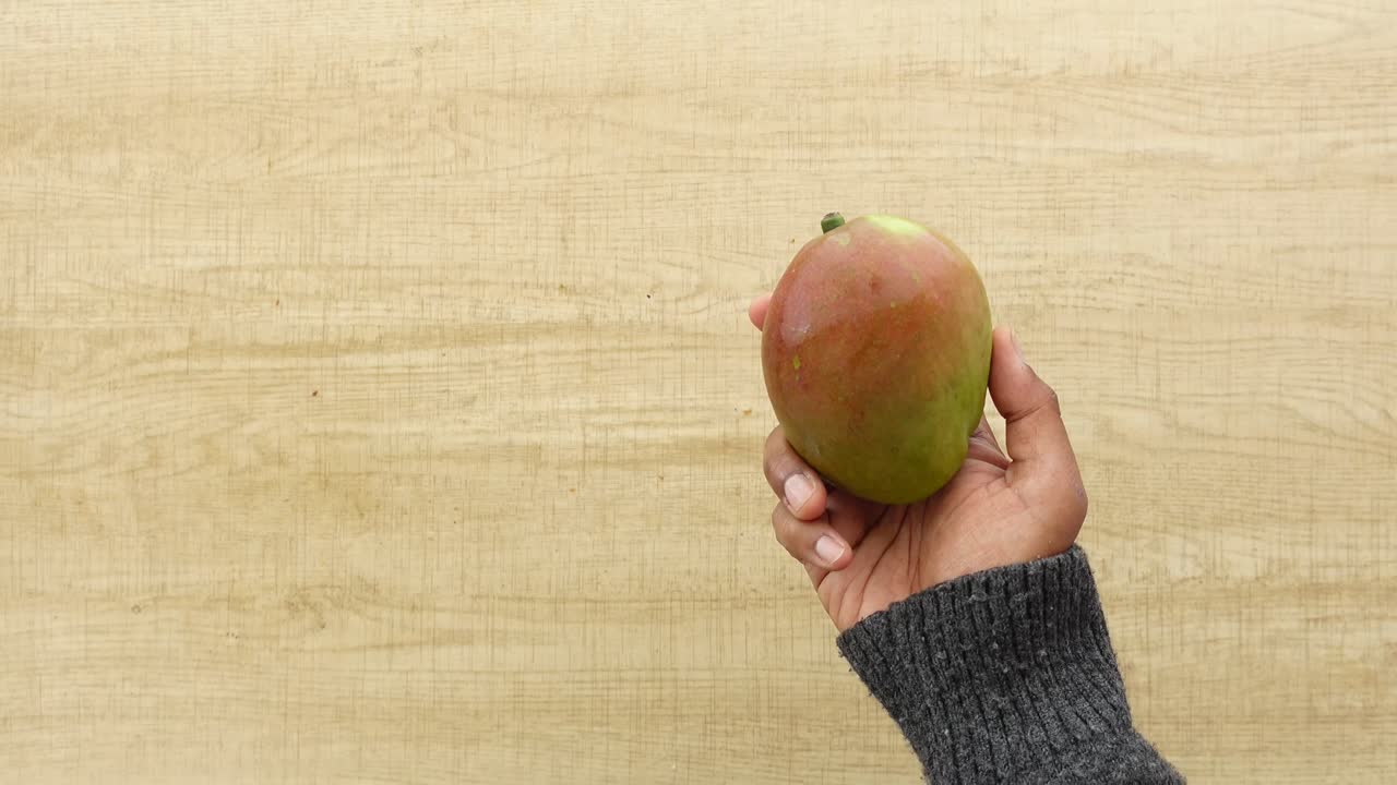 Holding a mango