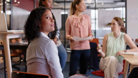 Portrait-of-biracial-businesswoman-with-diverse-colleagues-at-meeting,-slow-motion