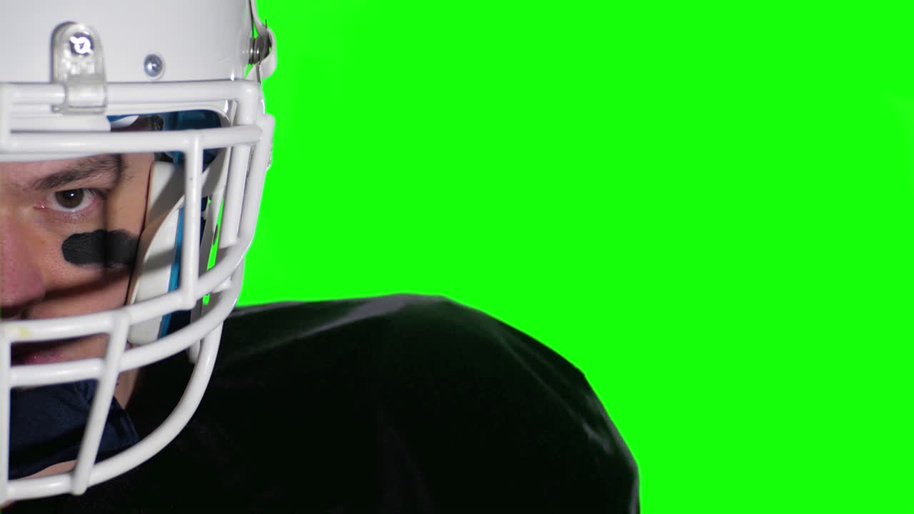 american football player ready for the game with space for statistics or news in front of GREEN SCREEN CHROMA KEY