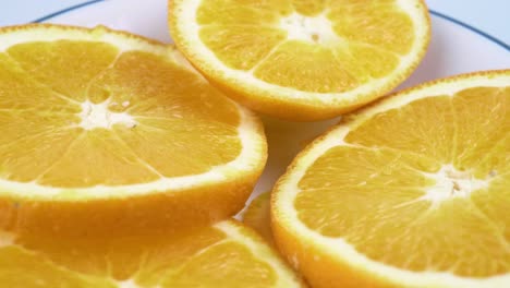 Close-up-fresh-valencia-orange-sliced-with-white-background-shallow-focus-and-slowly-rotating