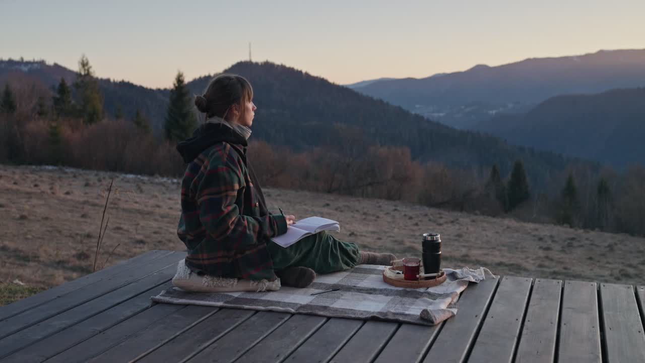 Woman reading in the mountains