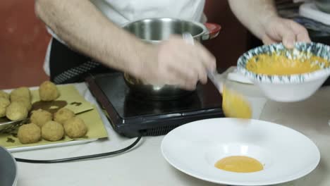 chef plating freshly cooked veggie balls with manong sauce