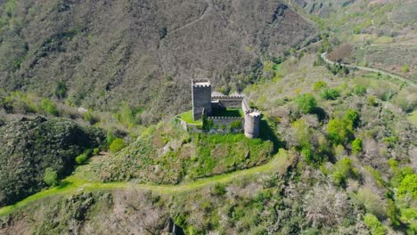 doiras castle on the hill in the banks of cancelada river in cervantes, spain