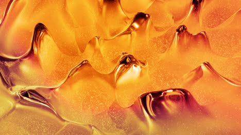 looped abstract background with wavy sparkling golden liquid pattern on shiny glossy surface. viscous blue fluid like surface of gold foil or brilliant glass. beautiful creative festive backdrop.