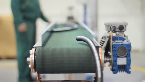 worker controlling on conveyor for production of industrial hoses