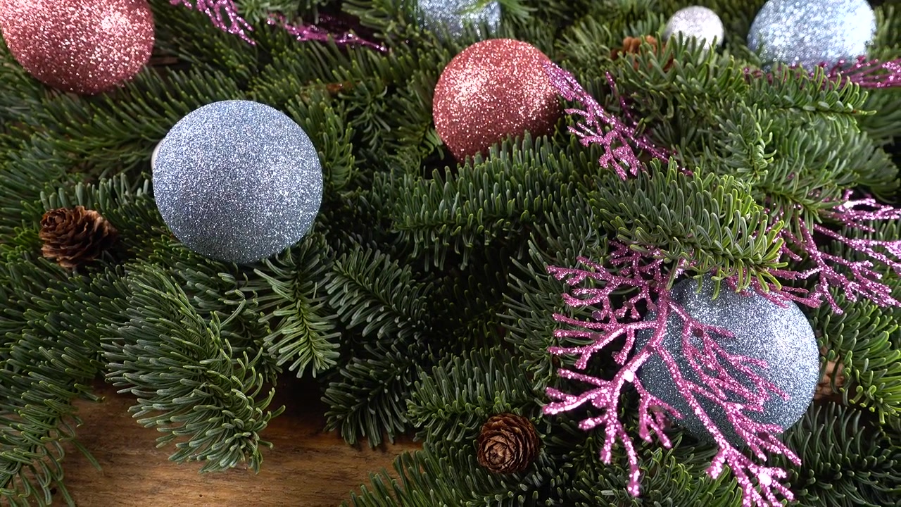 Ramo di Abies nobilis con pigne e palline di Natale su una vecchia tavola di legno vintage