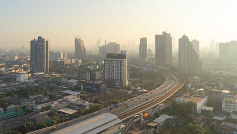 time lapse of aerial view of highway street road at bangkok downtown skyline, thailand. financial district and business centers in smart urban city in asia.skyscraper and high-rise buildings at sunset