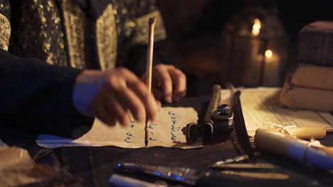 taking out a pen from the inkwell. writing letters in ancient times.