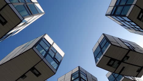 modern buildings from a low angle perspective against blue sky