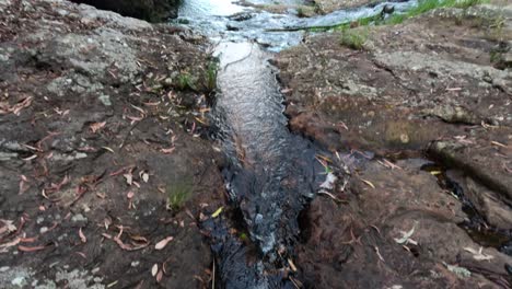 water stream flowing over rocky terrain