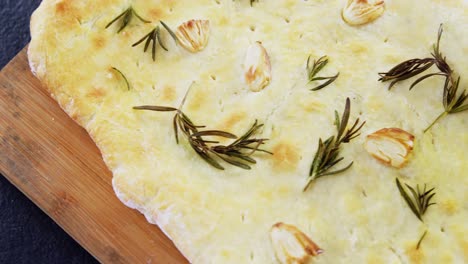 Garlic-bread-with-oil-on-wooden-board