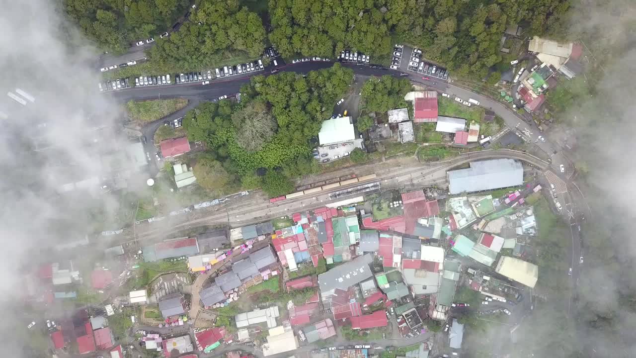 Top down drone shot of a foggy morning in a train station at Alishan, Taiwan.