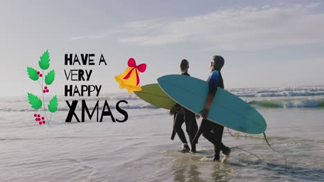 Animation-of-have-a-very-happy-xmas-over-senior-biracial-couple-with-surfboards-on-beach