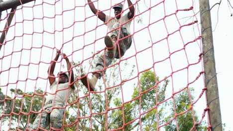 Military-soldier-climbing-rope-during-obstacle-course