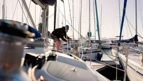 sailor man, rope and yacht by ocean