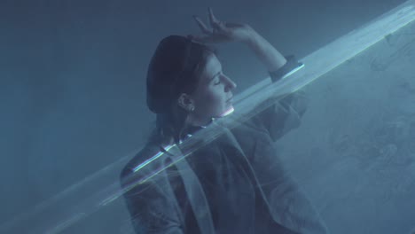 woman dancing in dark room with liquid sky laser light