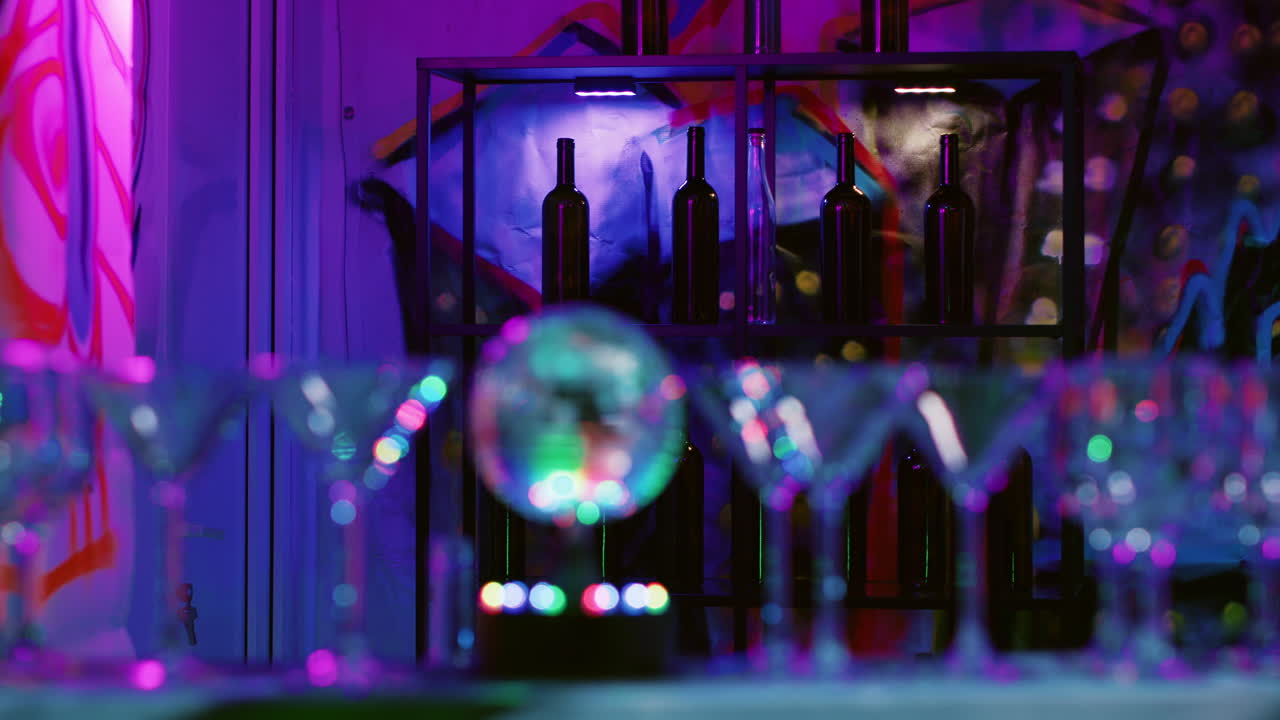 Wine bottles and glasses with disco ball in the foreground