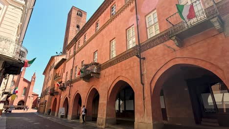 sunlit alley with italian architecture and flags