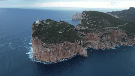 cape caccia, sardinia: aerial view in orbit of the cliff and lighthouse located on the cape on the island and during sunset