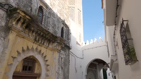 Pan-Up-View-From-Narrow-Street-In-Tangier-To-Reveal-Tall-Minaret-Tower
