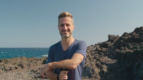 mature traveler on rocky seashore