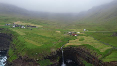 foggy faroese landscape with breathtaking view of mulafossur waterfall