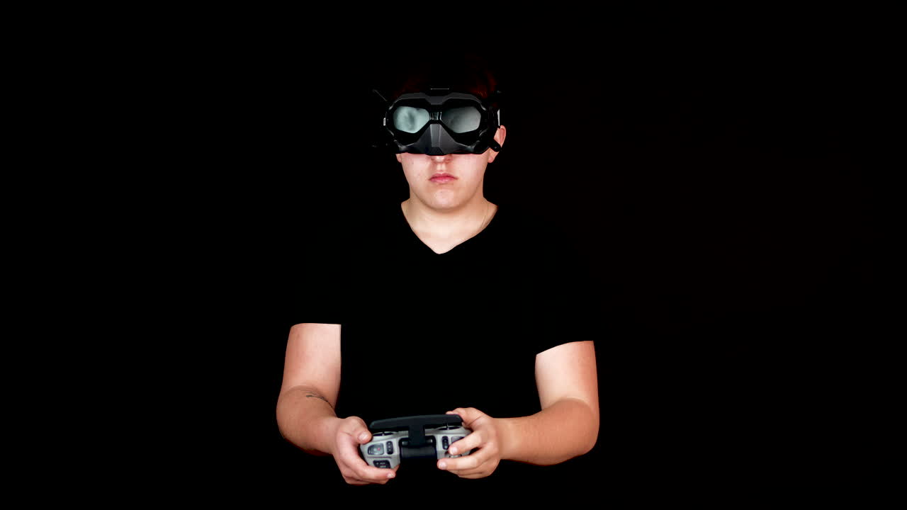 Young Man With VR Goggles and Remote Controller