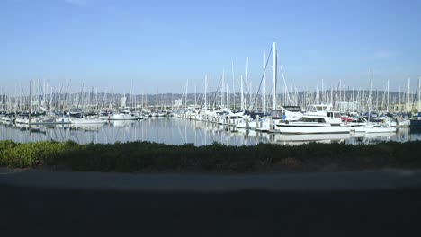 a sunny day with sailboats swaying in the light breeze