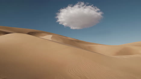 sand dunes and a floating cloud in a desert landscape