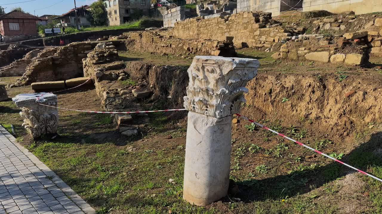 4K video of Prusias ad Hypium theater in Duzce. The ancient Roman ruins are nestled directly within the modern settlement of Konuralp, blending history with urban life