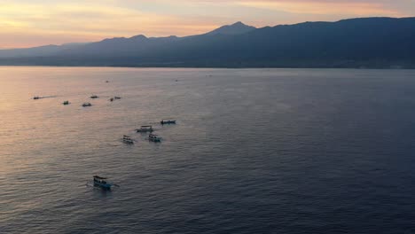 aerial-of-Indonesian-boats-on-sunrise-ocean-tour-in-tropical-waters-of-Lovina-Bali-Indonesia