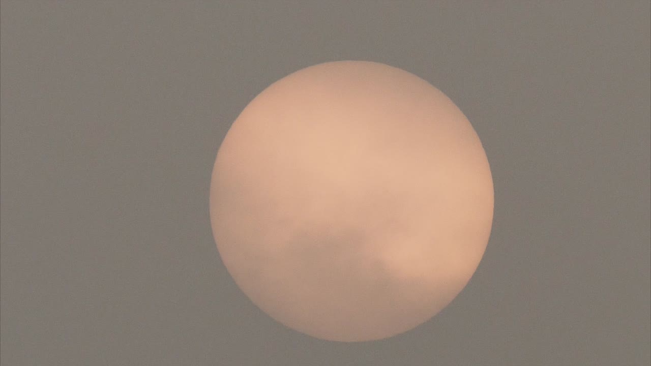 Close up of sun moving among heavy polluted air in morning until completely invisible, 4k footage, air pollution concept.