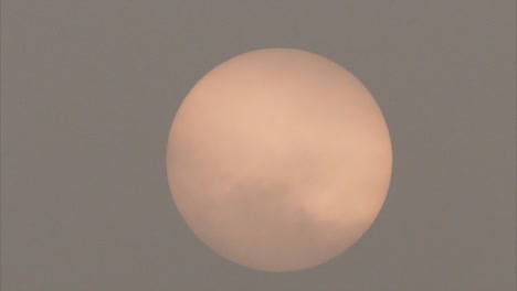 close up of sun moving among heavy polluted air in morning until completely invisible, 4k footage, air pollution concept.