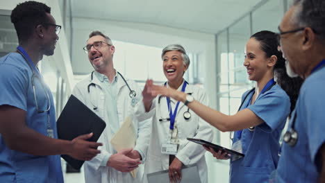Doctor,-high-five-and-meeting-in-healthcare
