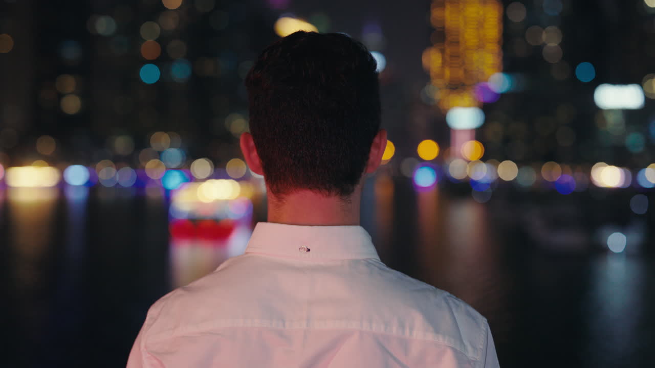 Person looking at city lights at night