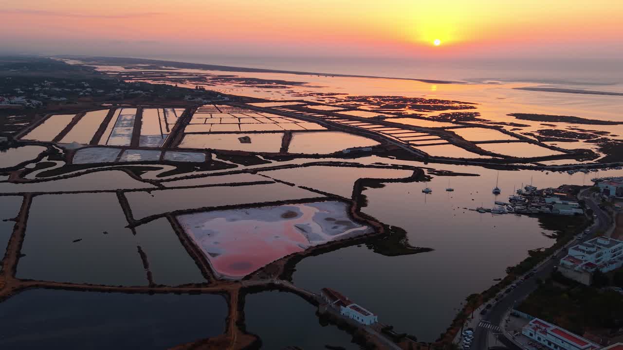 aerial shot around the salt pans at sunrise near Tavira and Fuseta in Ria Formosa Natural park in Algarve region, Portugal