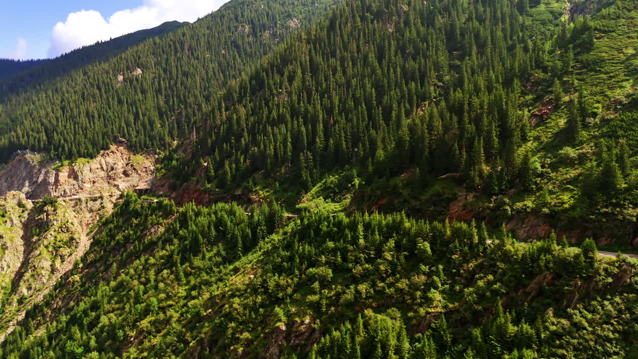 Lush green mountain landscape. Vibrant greenery covers the mountainside under a clear blue sky, showcasing the beauty of nature in a serene setting