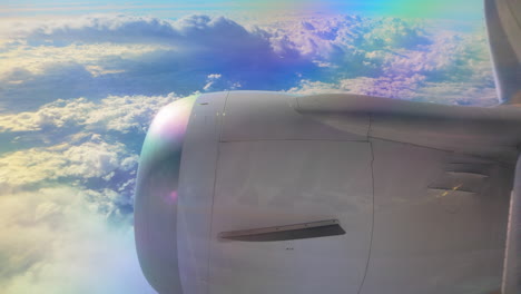 vibrant sky view from a plane window, focusing on the jet engine and clouds illuminated by sunlight.