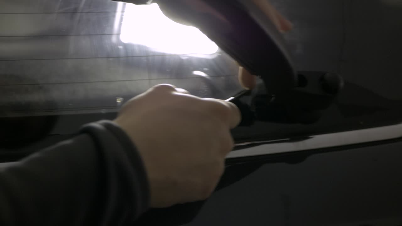 Cutting tinting foil on car window backlit