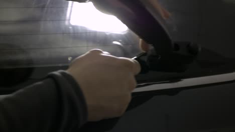 cutting tinting foil on car window backlit