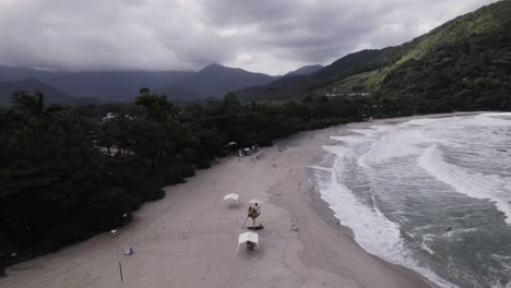 Pan-to-the-right-revealing-two-beaches-with-a-wooded-rock-in-the-middle-of-it