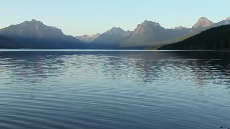 a view across lake macdonald at sunset, glacier national park, montana, usa