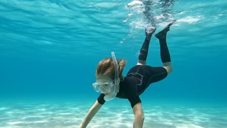child snorkeling underwater