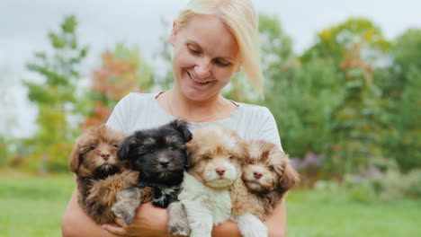 Happy-Woman-Holding-Puppies