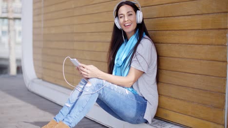 pretty trendy young woman enjoying her music